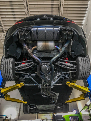 Full titanium catback exhaust on BMW M2 at DMW Motor Cars, expert BMW performance upgrades in Houston TX